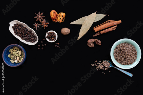 Indian Garam masala spices on black background photo