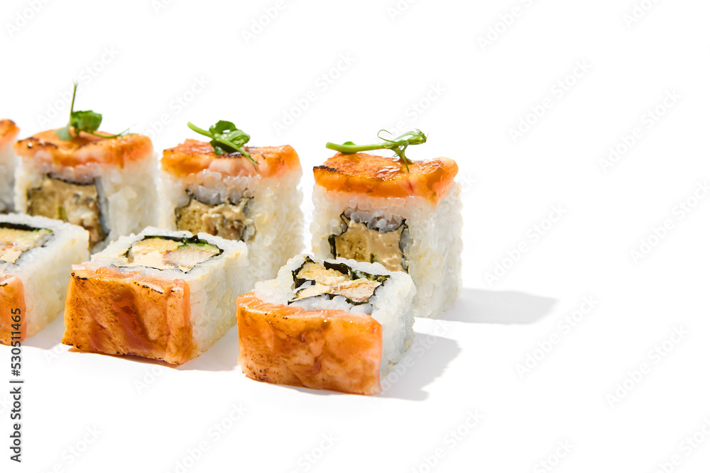 Maki sushi with baked salmon outside, shrimp, cucumber and cheese inside topped micro greens. Grilled salmon and shrimp maki roll isolated on white background Trendy sushi roll with burnt tuna fish Maki sushi with baked salmon outside, shrimp, cucumber and cheese inside topped micro greens. Grilled salmon and shrimp maki roll isolated on white background Trendy sushi roll with burnt tuna fish