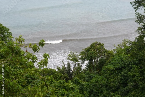 Malin Kundang rock formation at Padang, West Sumatra Indonesia. Air Manis Beach is closely related to the legend of Malin Kundang. photo