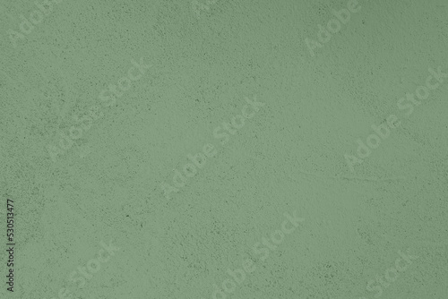 Saturated pastel warm gray green colored low contrast Concrete textured background. Empty colourful wall texture with copy space for text overlay and mockups. 2023, 2024 color trend