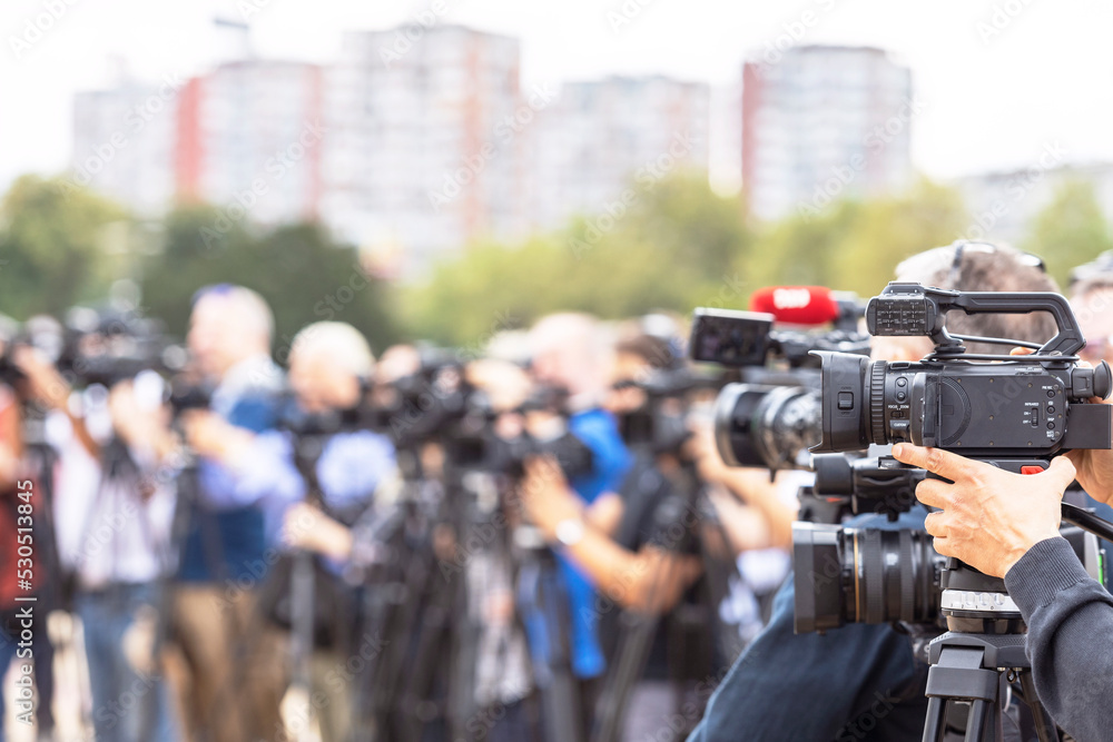 News conference. Filming media event with a video camera. News conference. Filming media event with a video camera.