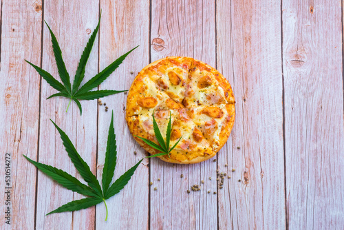 Homemade Cannabis food with Pizza on wooden background,Pizza Marijuana.
