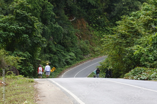 jogging on the road with up and down contours in the hills. people jogging on the street, Padang, West Sumatra, 18 May 2022