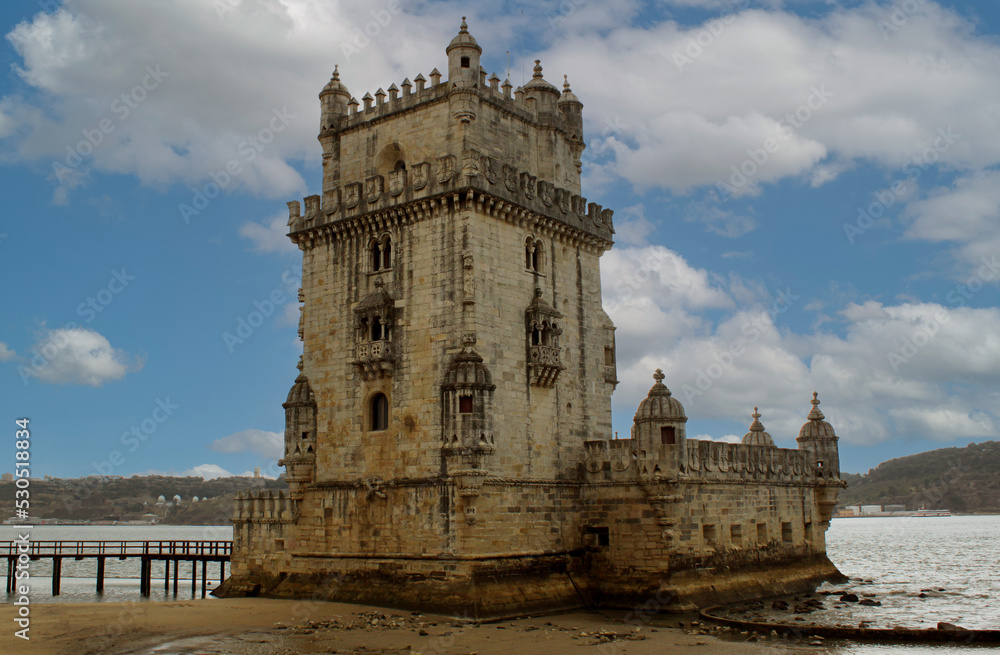 Exterior view of the historical Belem tower (Torre de Belém) on Tagus River in Lisbon, Portugal, Europe. 16th-century limestone fortification, an example of the Portuguese Manueline architecture style