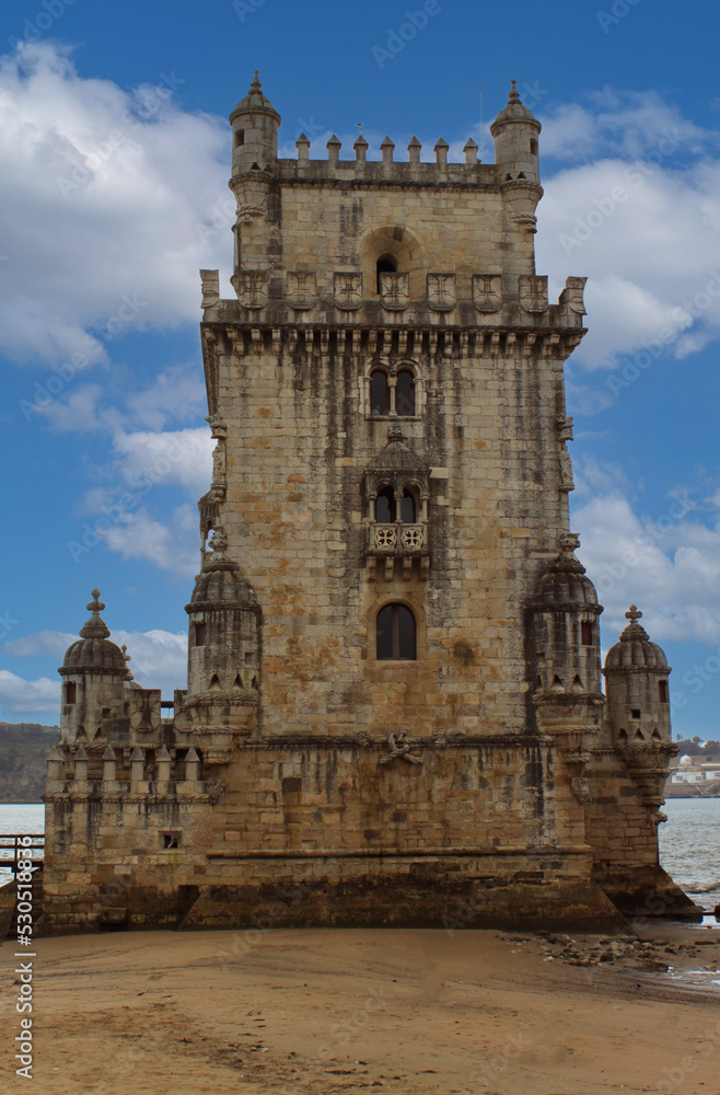 Exterior view of the historical Belem tower (Torre de Belém) on Tagus River in Lisbon, Portugal, Europe. 16th-century limestone fortification, an example of the Portuguese Manueline architecture style