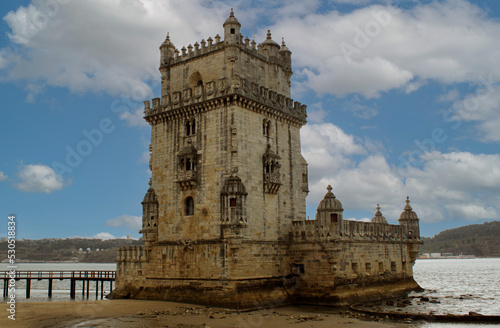 Exterior view of the historical Belem tower (Torre de Belém) on Tagus River in Lisbon, Portugal, Europe. 16th-century limestone fortification, an example of the Portuguese Manueline architecture style