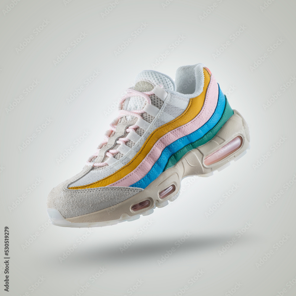 White sneaker with a diversity of colors, shoe on a white gradient  background, Yellow, pink, blue, green, men's / woman's fashion, sport shoe,  air, sneakers, lifestyle, concept, product photo, foto de Stock