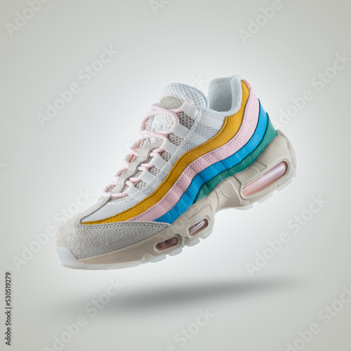 White sneaker with a diversity of colors, shoe on a white gradient background, Yellow, pink, blue, green, men's / woman's fashion, sport shoe, air, sneakers, lifestyle, concept, product photo,