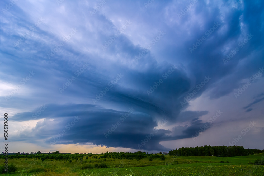Storm clouds over field, storm cell, extreme weather, dangerous storm Storm clouds over field, storm cell, extreme weather, dangerous storm