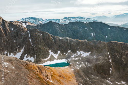 Mountain range landscape in Norway aerial view lake in rocks scandinavian nature scenery in Tromso photo