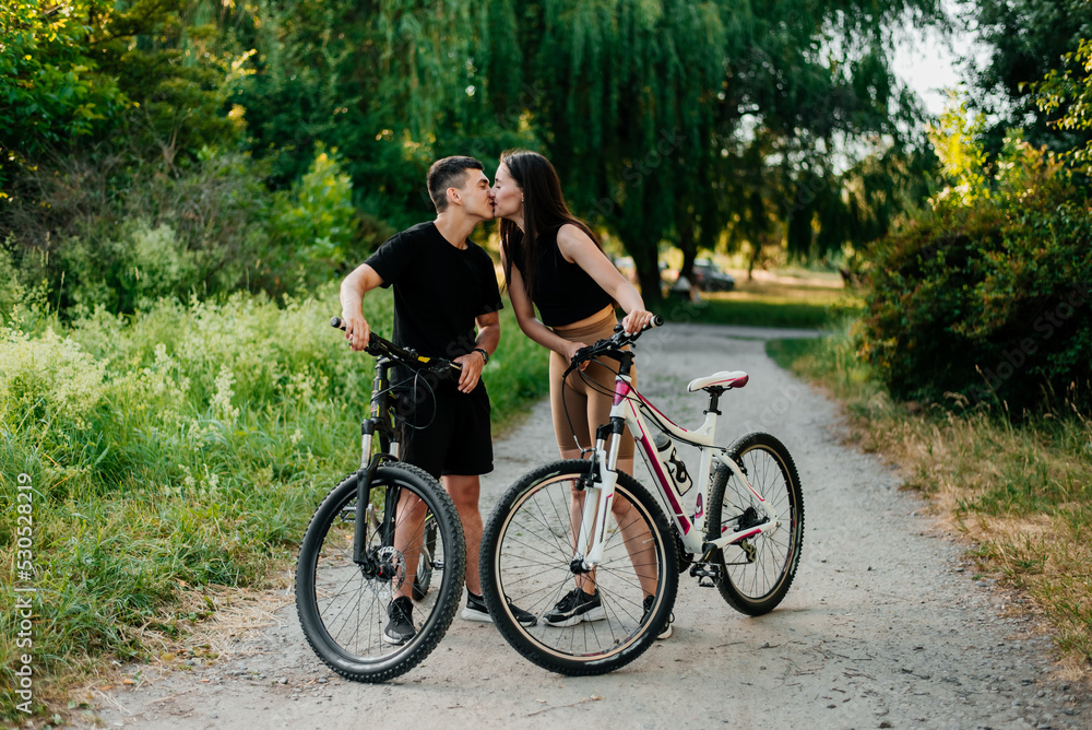 Happy young smiling couple with bicycles outdoor Happy young smiling couple with bicycles outdoor