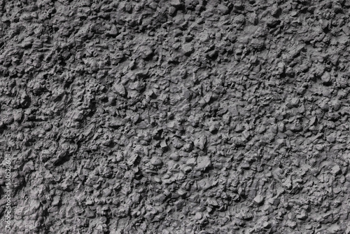 Background with an abstract pattern of textured plaster with nodules on the wall.