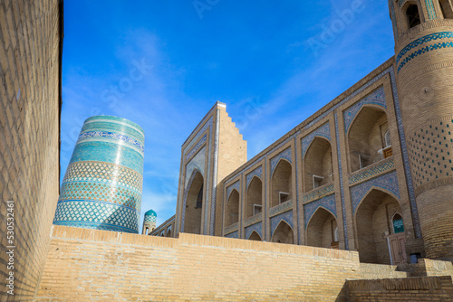 View to the unfinished Kalta Minor Minaret with Blue Mosaic Walls, which is built by Mohammed Amin Khan, in Khiva, Uzbekistan photo
