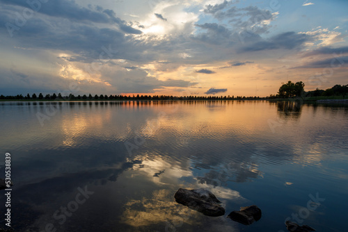 Dramatic sunset and reflections on the water on Patriot Lake in Shelby Farms Park, Memphis, TN.