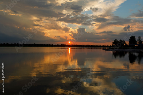 Dramatic sunset and reflections on the water on Patriot Lake in Shelby Farms Park, Memphis, TN.