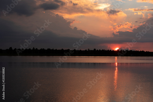 Dramatic sunset and reflections on the water on Patriot Lake in Shelby Farms Park, Memphis, TN.