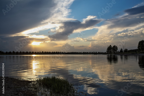 Dramatic sunset and reflections on the water on Patriot Lake in Shelby Farms Park, Memphis, TN.