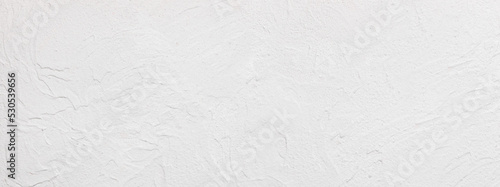 Mediterranean uneven lime plaster limestone wall surface -  handmade texture of white concrete wall  - background, panorama
