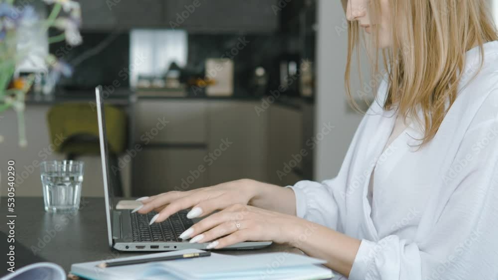 Close up of female hands typing on keyboard of laptop, working from home or hotel. Woman using computer, having remote work on distance Close up of female hands typing on keyboard of laptop, working from home or hotel. Woman using computer, having remote work on distance