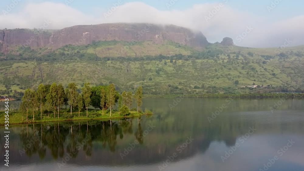 Panorama Of A Calm Lake, Islet, And Mountains At Daytime In Trimbakeshwar, Nashik, India. - aerial Panorama Of A Calm Lake, Islet, And Mountains At Daytime In Trimbakeshwar, Nashik, India. - aerial