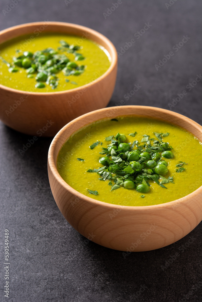 Green pea soup in a bowl on black background Green pea soup in a bowl on black background
