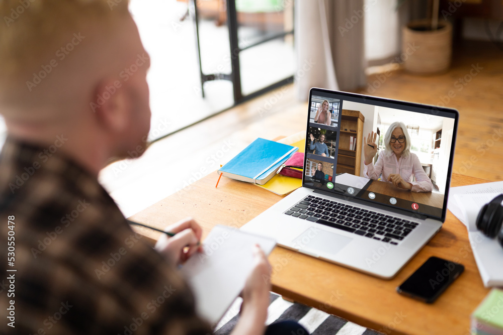 Albino african american man making laptop video call with diverse colleagues on screen Albino african american man making laptop video call with diverse colleagues on screen