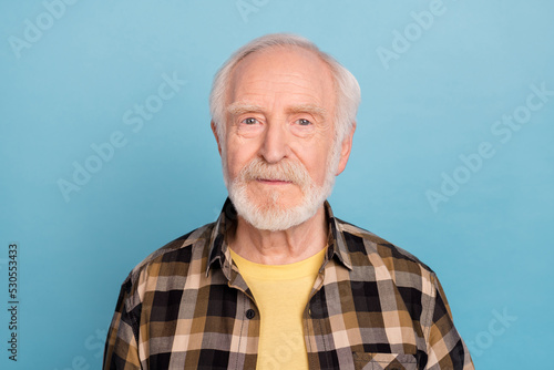 Photo of cheerful positive man pensioner dressed checkered shirt smiling isolated blue color background