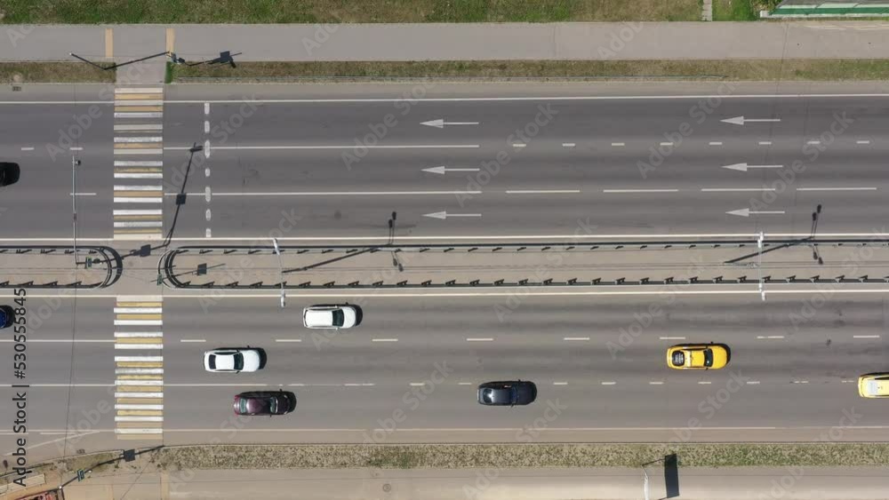 Bird eye view of cars traffic on a road. Yellow, white and black cars moving on the highway Bird eye view of cars traffic on a road. Yellow, white and black cars moving on the highway