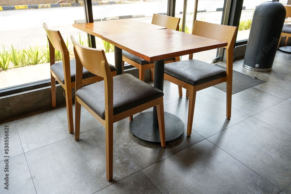Clean, neat, comfortable, minimalist and elegant table and chair arrangement in a starbucks restaurant or coffee shop.