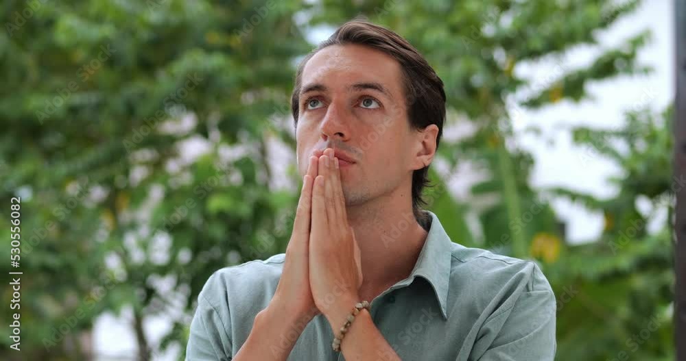 Peaceful religious mindful European christian guy praying to God, whispering prayer and making cherished wish, being in peace of mind. Spiritual growth. Concept of faith and religion. Worship the God Peaceful religious mindful European christian guy praying to God, whispering prayer and making cherished wish, being in peace of mind. Spiritual growth. Concept of faith and religion. Worship the God