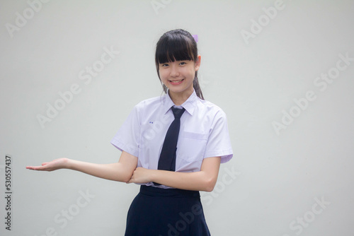 Portrait of thai Junior high school student uniform beautiful girl show hand