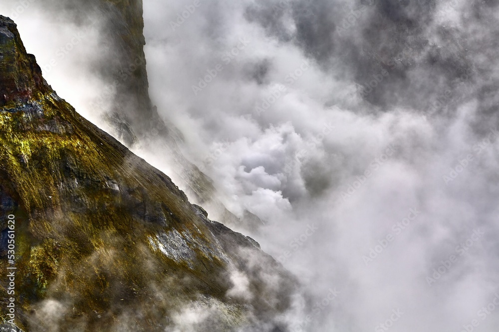 Rough mountain landscape with volcanic steam clouds Rough mountain landscape with volcanic steam clouds