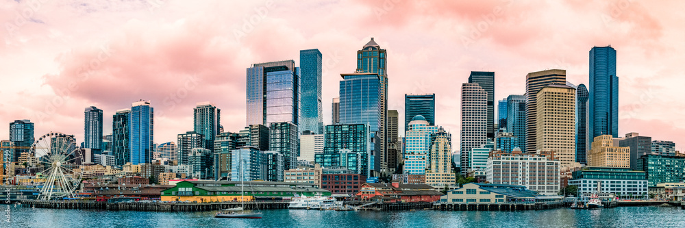 Seattle city skyline at sunset with soft orange colors of the clouds in the sky over Elliot Bay in Washington State Seattle city skyline at sunset with soft orange colors of the clouds in the sky over Elliot Bay in Washington State