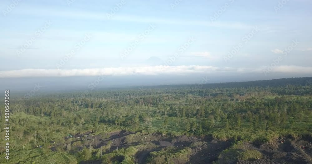 Aerial wide shot of damaged forest landscape on slope of Volcano during sunny day in Indonesia - Sand mining activities in Asia Aerial wide shot of damaged forest landscape on slope of Volcano during sunny day in Indonesia - Sand mining activities in Asia