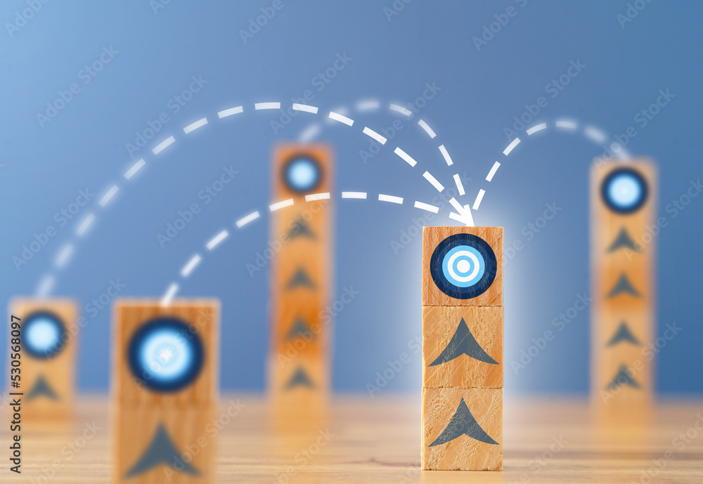 Close up photo of stacked wooden blocks with target icon linked to ...