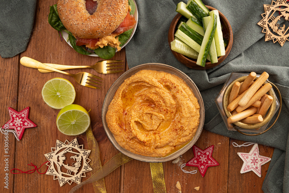 Hummus on Christmas table with decorations. Hummus on Christmas table with decorations.