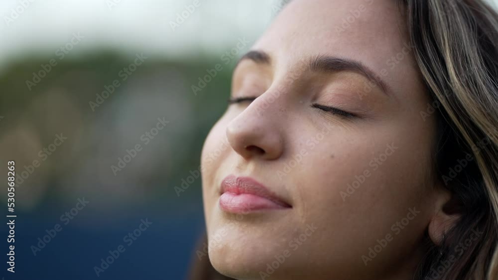 Young hispanic woman closing eyes in meditation. Millennial 20s girl opening eyes smiling. Closeup female person face Young hispanic woman closing eyes in meditation. Millennial 20s girl opening eyes smiling. Closeup female person face