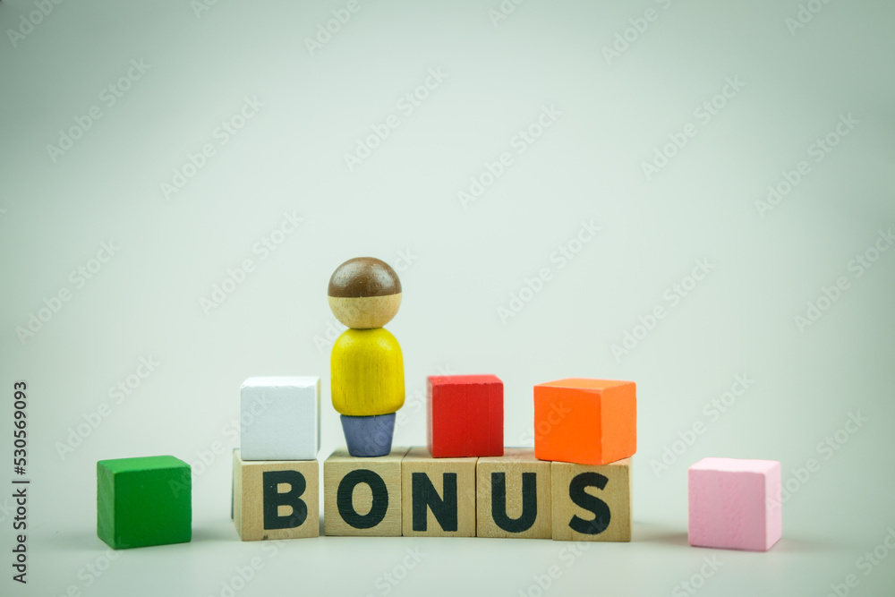 Letter block in word BONUS and magnet magnetize human motivation in work. Yearly bonus concept. Bonus is motivation in work. The concept of receive bonuses, rewards and preferences. Salary increase Letter block in word BONUS and magnet magnetize human motivation in work. Yearly bonus concept. Bonus is motivation in work. The concept of receive bonuses, rewards and preferences. Salary increase