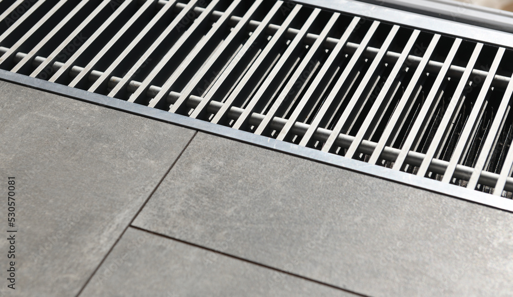 Heating grill with ventilation in the floor in laminate.. Forced hot-air heating systems are extremely popular and feature vents like this to channel the hot air throughout the house. Heating grill with ventilation in the floor in laminate.. Forced hot-air heating systems are extremely popular and feature vents like this to channel the hot air throughout the house.