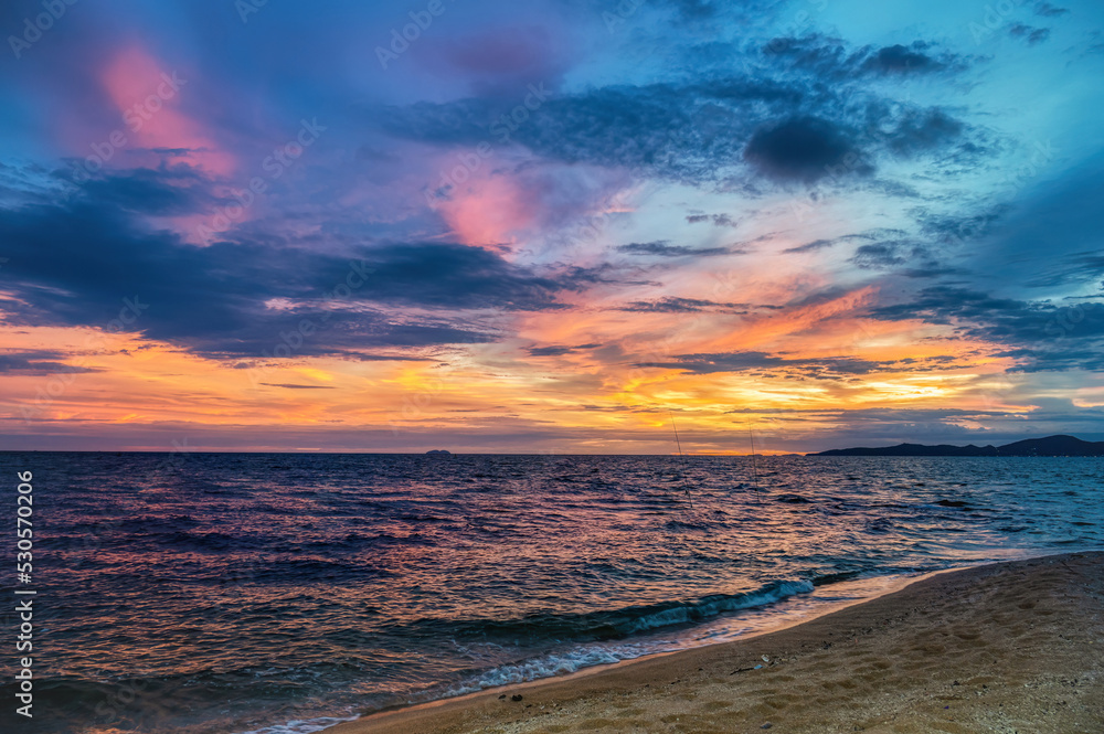 Sunset at a beach near Pattaya, Thailand, during the monsoon (rainy) season, when the skies can produce dramatic colors and cloudscapes