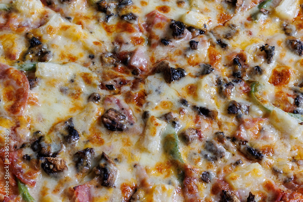 close up of cheesy pizza with mushrooms green pepper and ham close up of cheesy pizza with mushrooms green pepper and ham