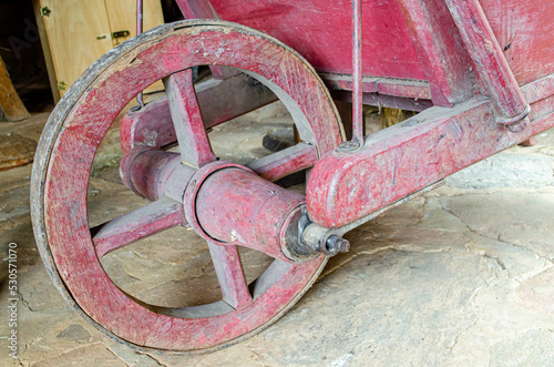 A vintage rustic red wooden wheelbarrow
