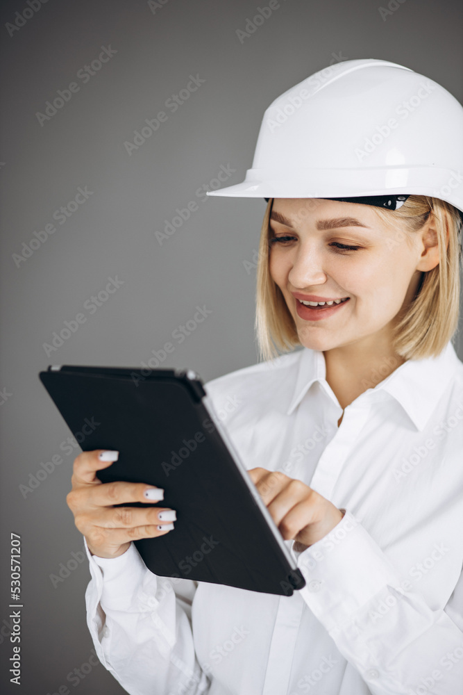 Woman architect reading engineer plan on tablet Woman architect reading engineer plan on tablet