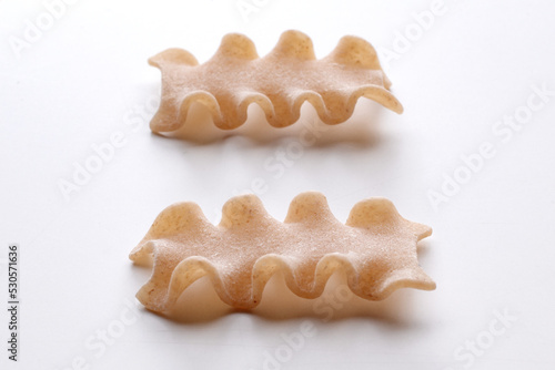 small composition of whole durum wheat pasta on a white background