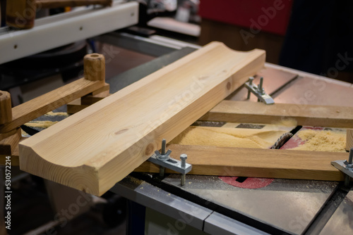 Carpenter workbench with industrial circular saw machine, wooden boards. Industrial, woodwork, carpentry, craftsmanship and woodwork concept