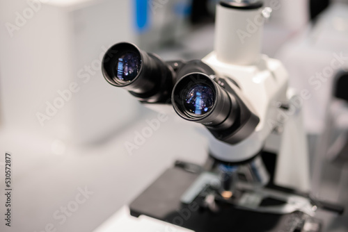Fototapeta Naklejka Na Ścianę i Meble -  Ocular lens, eyepieces of white optical microscope - close up. Science, biology, optical, laboratory equipment and education concept
