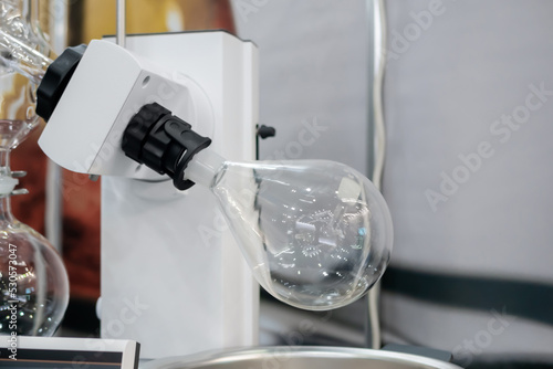 Laboratory rotary evaporator for homogenization process - chemical flask for evaporate solvent from liquid at pharmacy factory or medical exhibition. Pharma, Chemistry and science concept photo