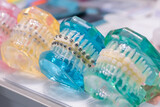 Transparent colorful human jaws with orthodontic braces, metal and ceramic brackets. Stomatology, education, medicine concept
