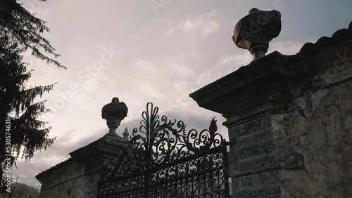 Detail of mediterranean gate. Architecture design of iron and stone gate of famous Villa Balbiano at lake como italy luxury wedding venue location - cinematic slowmotion photo