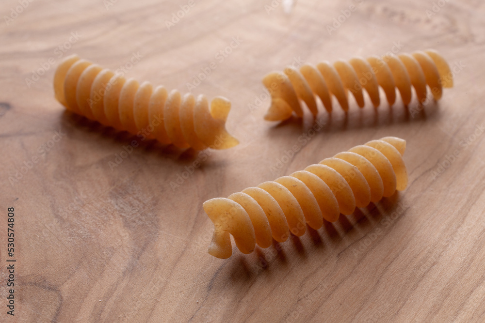 whole wheat durum wheat pasta on wooden background whole wheat durum wheat pasta on wooden background